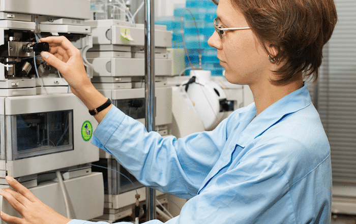 scientist using an HPLC machine 1 - Expert Tips for Maintaining a Certified Pre-Owned Agilent HPLC System